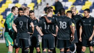 nashville sc players huddle together