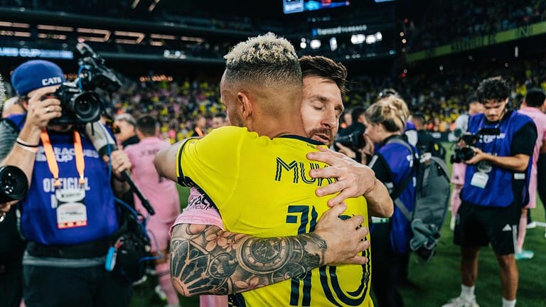 lionel messi hugs hany mukhtar after a match