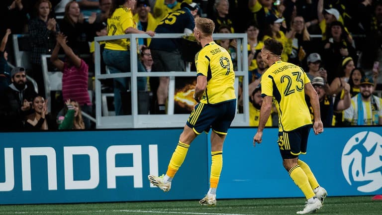 sam surridge and taylor washington celebrate after a goal