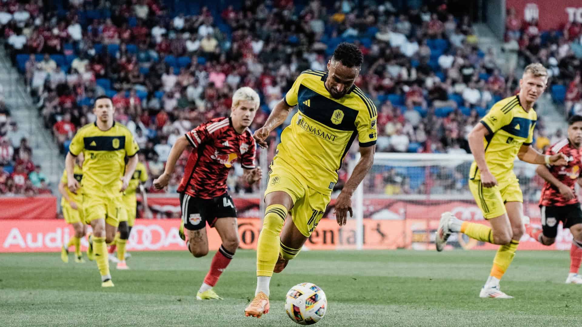 mukhtar drives with the ball at new york red bulls